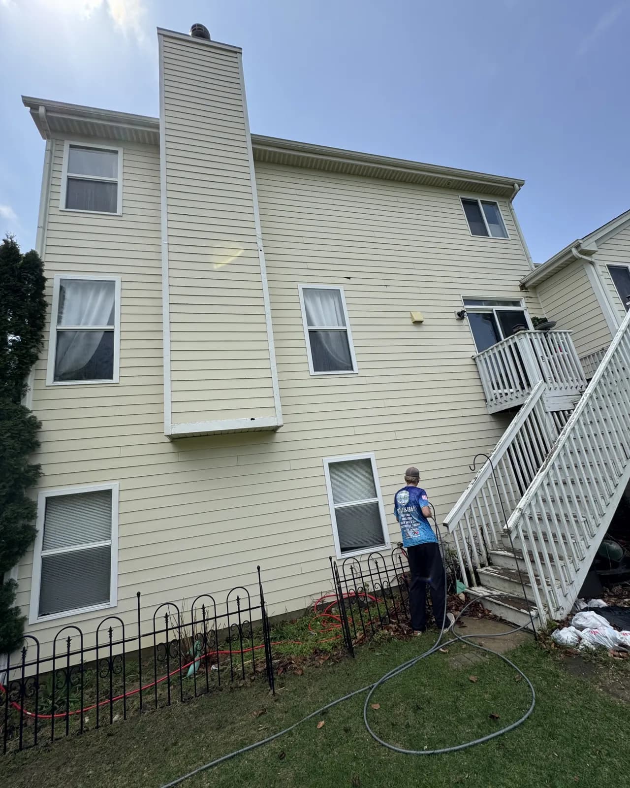 Washing a three-story sided home