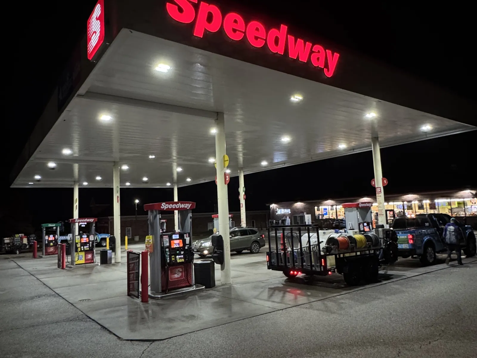 Cleaning a gas station canopy at night